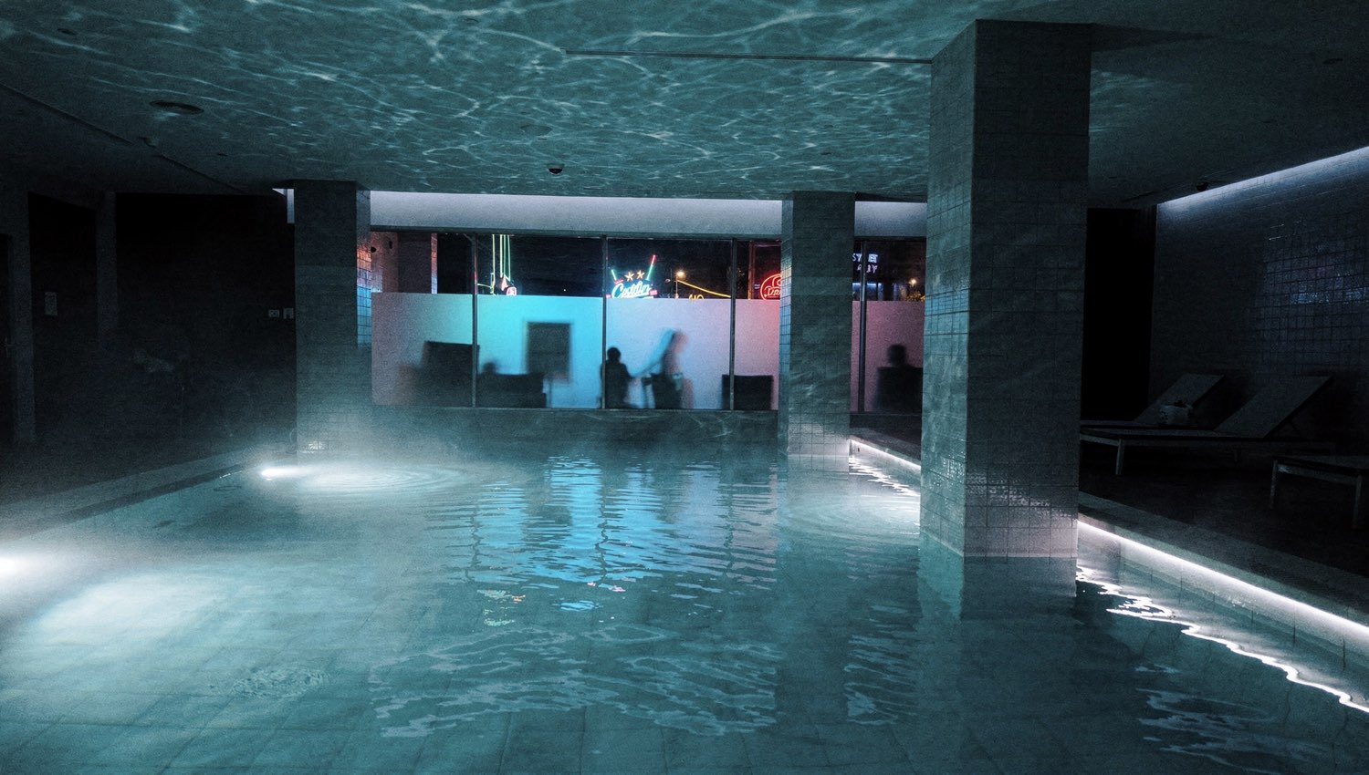ServerHopCollective spa pool at night with cool-blue reflection